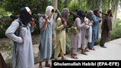 FILE: Former Taliban militants surrender their weapons during a reconciliation ceremony in the eastern Afghan city of Jalalabad.