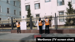 Национал-большевики прикрепляют плакаты к ограждению посольства Казахстана в Москве. 25 августа 2021 года