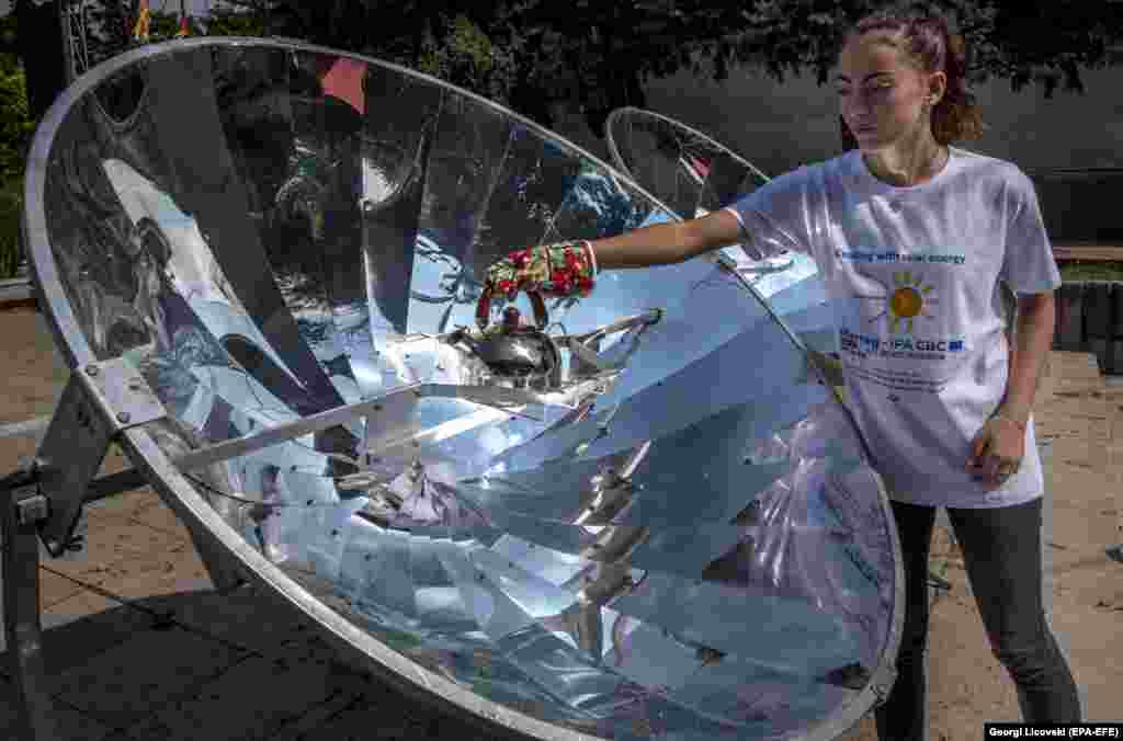 A high-school student boils water for tea on a solar furnace in the center of Negotino, North Macedonia, on September 19. (epa-EFE/Georgi Licovski)