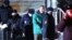 Kremlin critic Aleksei Navalny (in green jacket) is escorted by police officers after a court hearing in Khimki outside Moscow on January 18. 