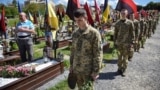 Ukrainian military cadets visit the graves of Ukrainian soldiers who were killed during Russia's invasion of Ukraine to mark the Orthodox feast of Palm Sunday at the Lychakiv cemetery in Lviv on April 28.