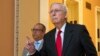 Senate Majority Leader Mitch McConnell walks back to the Senate chamber during the impeachment trial of President Donald Trump.