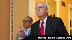 Senate Majority Leader Mitch McConnell walks back to the Senate chamber during the impeachment trial of President Donald Trump.