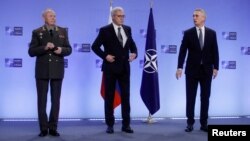 Russian Deputy Defense Minister Aleksandr Fomin (left), Russian Deputy Foreign Minister Aleksandr Grushko (center), and NATO Secretary-General Jens Stoltenberg during a NATO-Russia Council meeting in Brussels on January 12.