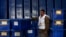 An Afghan Election Commission worker stands by ballot boxes and election material at a warehouse in Kabul. Turnout is expected to be much higher than in 2009.