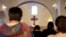 Iraqi Christians fleeing the violence in the towns of Qaraqush and Bartala, both east of the city of Mosul in the northern province of Nineveh, pray at the St. George Church in the Kurdish autonomous region's capital, Irbil.