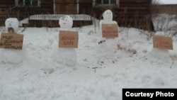 Yelena Kalinina's snowmen in the village of Zachachye in the northern Arkhangelsk region.