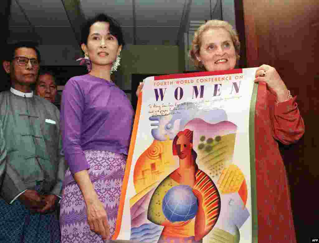 U.S. Ambassador to the United Nations Madeleine Albright presents a poster of the Fourth Women Conference during her meeting with Suu Kyi at her residence in Yangon on September 9, 1995.