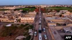 Syrian evacuees from Waer, the last opposition-held district Homs, arrive in the city of Al-Bab in northern Aleppo Province on April 18.