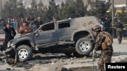 Afghan security forces inspect the site of a blast in Kabul, Afghanistan on December 28.