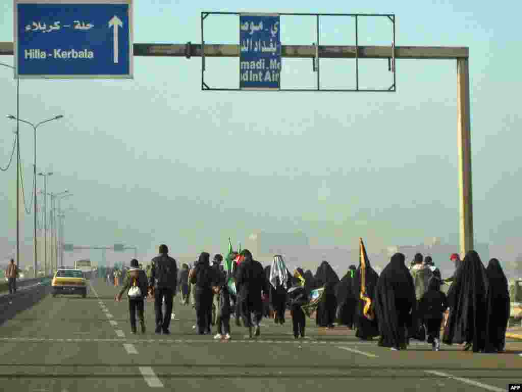 Shi'ite Muslim pilgrims walk on a main highway linking Baghdad to the central shrine city of Karbala, 120 kilometers south of the capital, on January 20 on their way to attend the upcoming Arbain religious festival marking the 40th day after Ashura, which commemorates the killing of the Prophet Muhammad's grandson, the Imam Hussein, in the seventh century. Photo by Ali al-Saadi for AFP