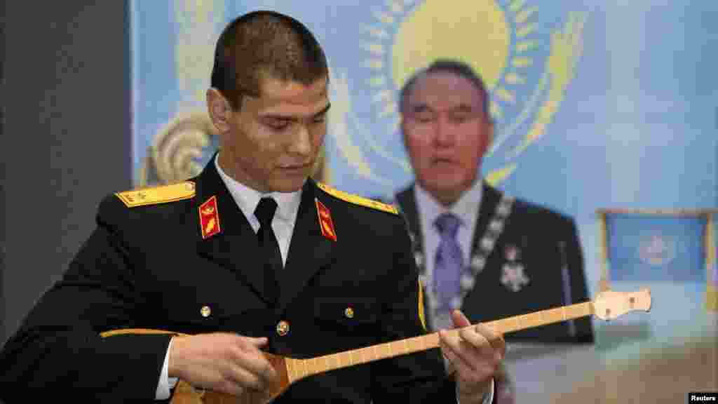 A cadet plays a dombra at the opening of an exhibition to mark the inaugural Day of the First President in the Central National Museum.