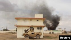 Smoke billows from a building after a Taliban attack in Helmand province March, 2016