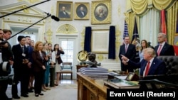 US President Donald Trump talks to reporters at the White House in Washington on September 18.