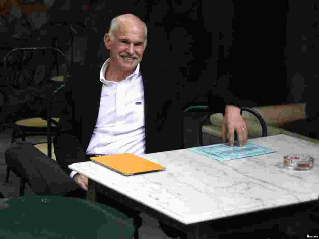 Former Greek Prime Minister George Papandreou sits in a cafeteria near the parliament in Athens amid crucial debt crisis talks. He has been replaced by former European Central Bank Vice President Lucas Papademos. (Photo for Reuters by Giorgos Kontarinis)