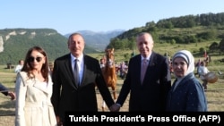 Turkey's President Tayyip Erdogan and Azerbaijan's President Ilham Aliyev, accompanied by their wives Emine Erdogan and Mehriban Aliyeva, visit Shusha on June 15, 2021.