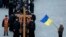 Orthodox priests and others take part in a procession commemorating the third anniversary of Ukraine's pro-European Union (EU) mass protests in central Kyiv.