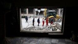 Emergency responders in Tehran work at the site of the Qatari Al-Araby TV and business building, which was damaged by an air strike on March 29.