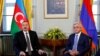 SWITZERLAND -- Azerbaijani President Ilham Aliyev (L) poses next to Armenian President Serzh Sarkisian at the opening of talks in Geneva, October 16, 2017