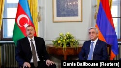 SWITZERLAND -- Azerbaijani President Ilham Aliyev (L) poses next to Armenian President Serzh Sarkisian at the opening of talks in Geneva, October 16, 2017