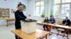 Kosovo: A citizen in a voting station in Prishtina