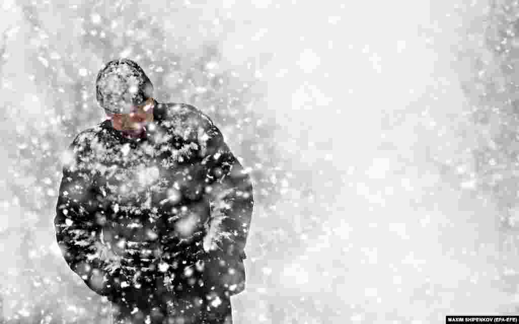 &nbsp;A man walks on a street during snowfall in the town of Podolsk, outside the Russian capital, Moscow.&nbsp;