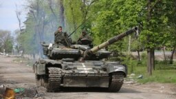 Moscow-backed separatist fighters in an armored vehicle patrol an area of the southern Ukrainian port city of Mariupol on May 4.