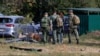 Russian investigators work in the courtyard of a damaged multistory residential building on September 10 following an alleged Ukrainian drone attack on Ramenskoye in the Moscow region.