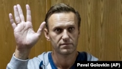 Aleksei Navalny gestures in a courtroom in Moscow in August.