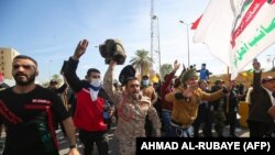 Supporters and members of the Hashed al-Shaabi paramilitary force gather during a demonstration outside the US embassy in the Iraqi capital Baghdad on January 1, 2020. 