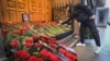 A man lays flowers at Azerbaijan's Embassy in Moscow on December 26, paying tribute to the victims of an Azerbaijan Airlines plane crash in Kazakhstan which killed dozens of people.