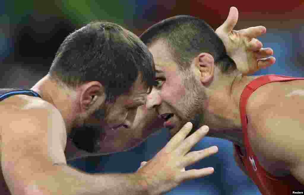 Nikolay Bayryakov of Bulgaria and Javid Hamzatov of Belarus compete in the Greco-Roman wrestling final, 85-kilogram division.