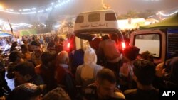 An ambulance arrives in Tahrir square after unidentified men attacked an anti-government protest camp in Baghdad late on December 6, 2019