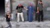 A Syrian rebel carries a homemade explosive device as others stand back to let him pass during fighting in Aleppo, which could have a crucial impact on the course of events in Syria. 