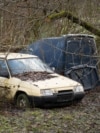 Wreck of yellow Czech Skoda Favorit 136L car parked in bush