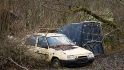 Wreck of yellow Czech Skoda Favorit 136L car parked in bush