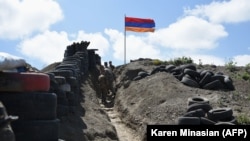 ARMENIA -- Soldiers walk in a trench at an Armenia border post near the village of Sotk, June 18, 2021