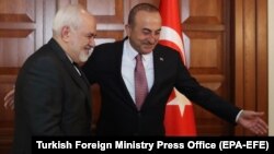 Turkish Foreign Minister Mevlut Cavusoglu (right) meets with Iranian Foreign Minister Mohammad Javad Zarif in Ankara on April 17.