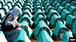 A Bosnian Muslim woman mourns over a casket at the Potocari Memorial Center during the 2008 burial of 308 Bosnian Muslims killed by Bosnian Serb forces in Srebrenica.