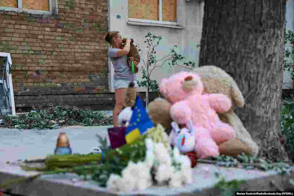 Some residents brought flowers and toys to the scene.Olha said she knew many of her neighbors who lived in the building, including a man who was killed in the attack."My husband used to talk to him a lot," she added, struggling to continue. "It's a nightmare."
