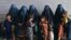 Afghan women wait during the visit of UN High Commissioner for Refugees Filippo Grandi at the Azakhel Voluntary Repatriation Center in Khyber Pakhtunkhwa Province on September 9.
