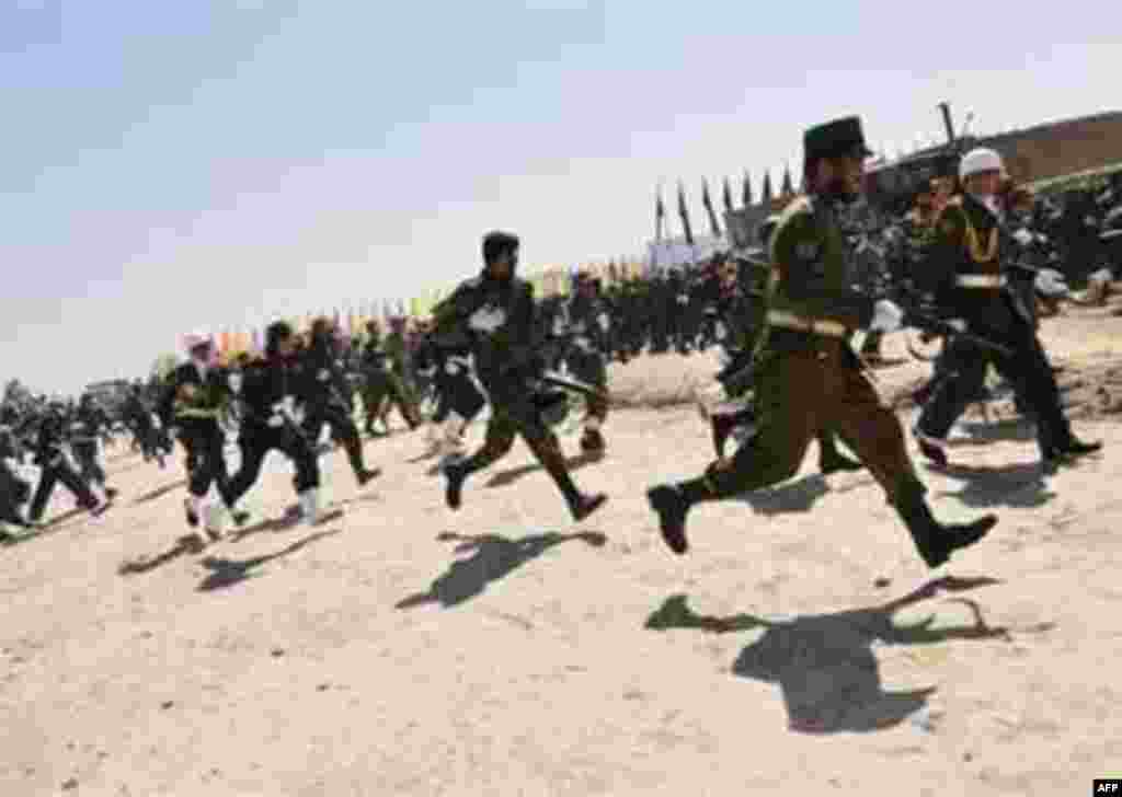 Afghan President Hamid Karzai escapes an assassination attempt. - Afghan military soldiers run to take up positions after gun fire was heard during a military parade in Kabul on April 27, 2008. President Hamid Karzai is safe after an attack on a parade of the Afghan military in Kabul.