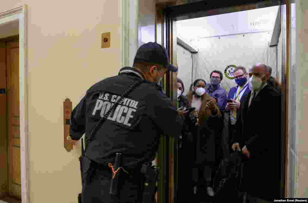 U.S. Capitol Police evacuate journalists and House press staff members from the Capitol to a connected office building, in Washington, U.S., January 6, 2021. REUTERS/Jonathan Ernst