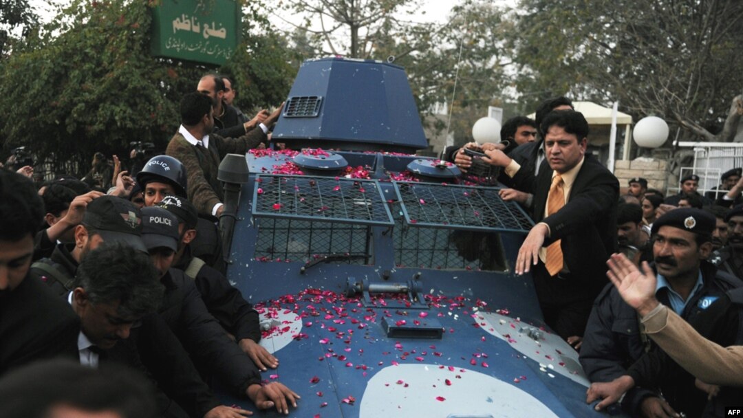 Police escort an armored vehicle carrying arrested bodyguard Malik Mumtaz Hussain Qadri, the alleged killer of Punjab Governor Salman Taseer in Rawalpindi on January 6.