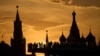 People watch and photograph a sunset behind the Kremlin at Zaryadye Park in Moscow. 