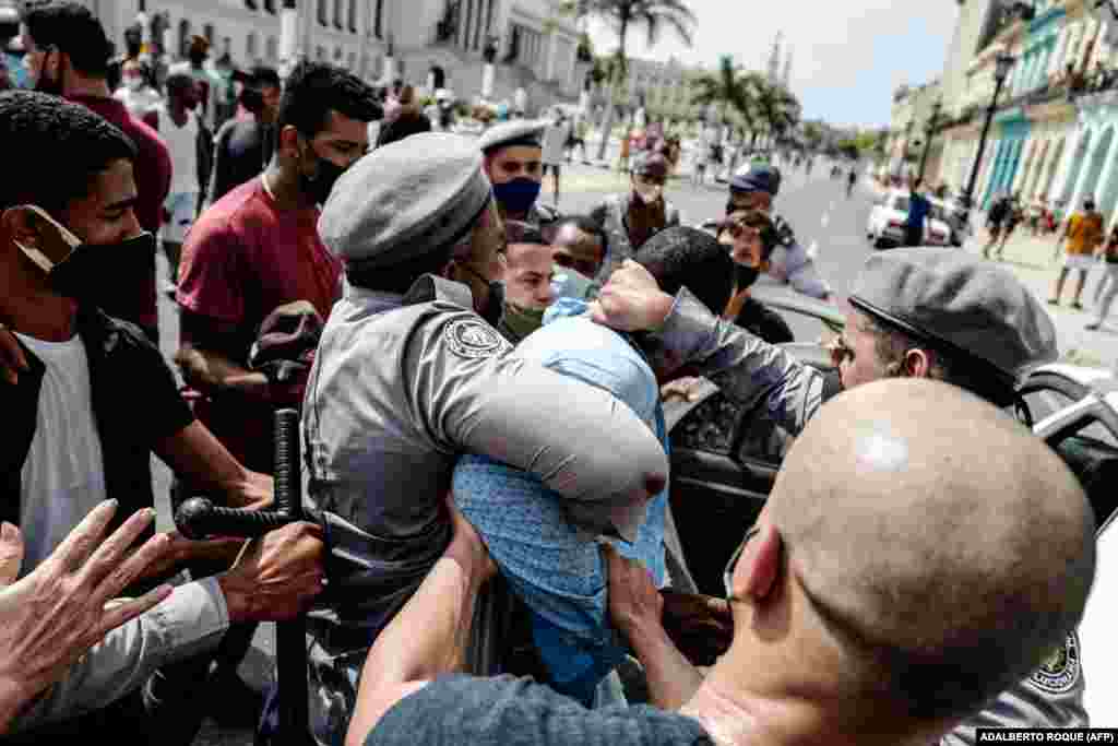 A man is arrested during a demonstration against the government of Cuban President Miguel Diaz-Canel in Havana, on July 11, 2021.