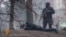 A still photo from RFE/RL Ukrainian Service video (below) showing Ukrainian security forces with a Kalashnikov assault rifle and sniper rifle, respectively, in a confrontation with protesters in Kyiv on February 20, when dozens of Euromaidan supporters were gunned down.