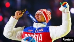 Russian Aleksandr Legkov celebrates as he receives his gold medal for the men's cross-country 50-kilometer race at the Sochi Olympics. He has since been banned for life for doping.