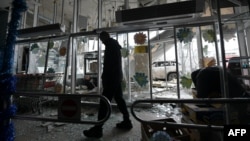 A man walks inside a damaged store following shelling, which local officials called a Ukrainian military strike, in Donetsk in Russian-occupied Ukraine on January 10. 