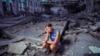 Kateryna Tabashnyk, a high jumper, sits for a portrait in June at the athletics arena of the Polytechnic sports complex, which was destroyed by a Russian rocket attack, in Kharkiv, Ukraine.